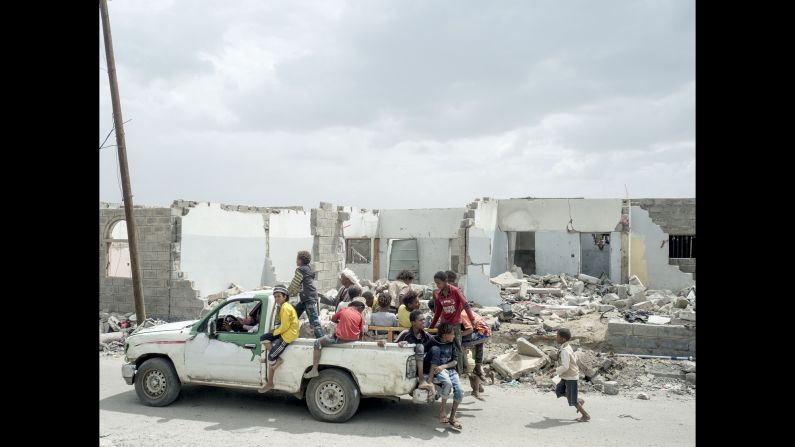 People in Sanaa, Yemen, leave an area that was destroyed by an airstrike in early September. Photographer Lorenzo Meloni began documenting Yemen's civil war in April.