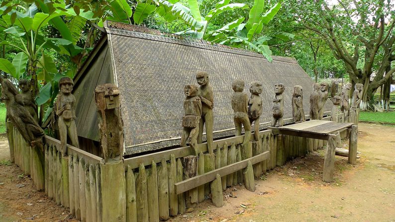 Prized possessions such as a TV or bicycle may be laid to rest with the dead, Simple wooden carvings of figures are placed on the boundary of the grave. This Giarai tomb is part of the Vietnam Museum of Ethnology in Hanoi.
