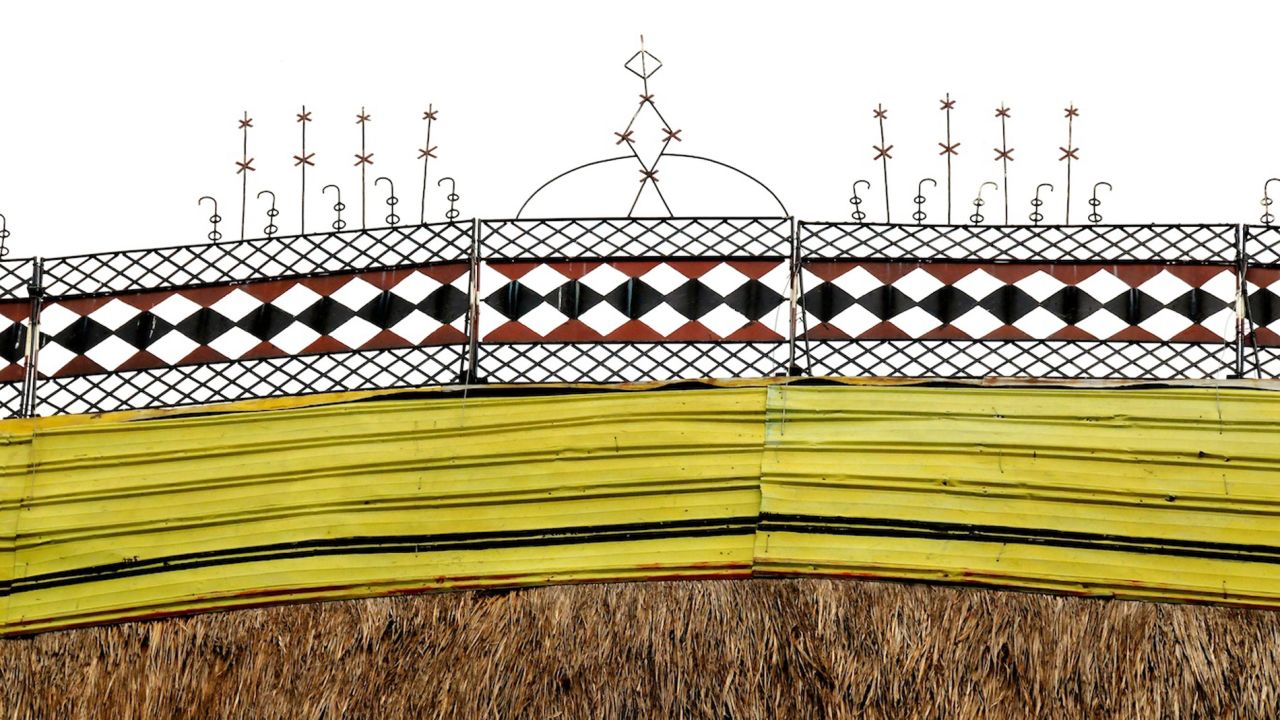 The peaks of the blade-shaped roofs are decorated with distinctive patterns unique to each village. <br />