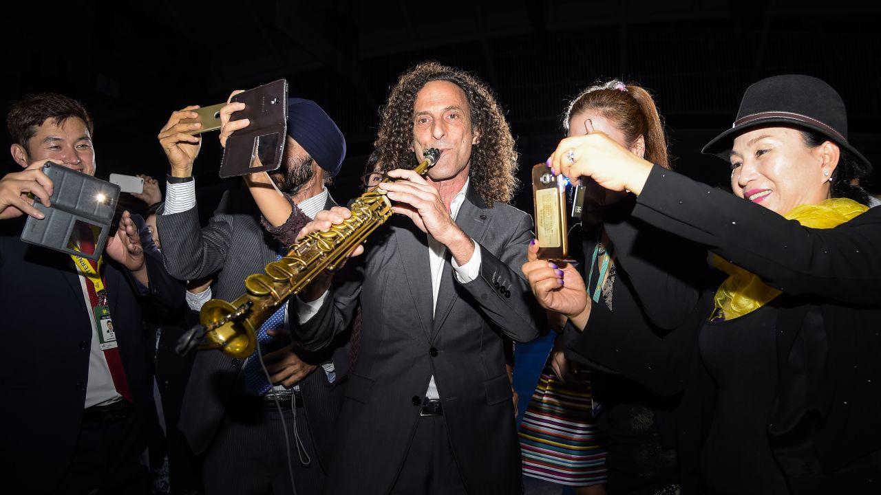 People in Incheon, South Korea, take selfies with recording artist Kenny G during the opening ceremony of the Presidents Cup golf tournament on Wednesday, October 7.
