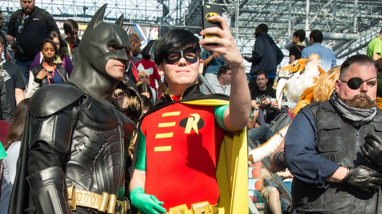 People dressed as Batman and Robin take a selfie during New York Comic Con on Friday, October 9.