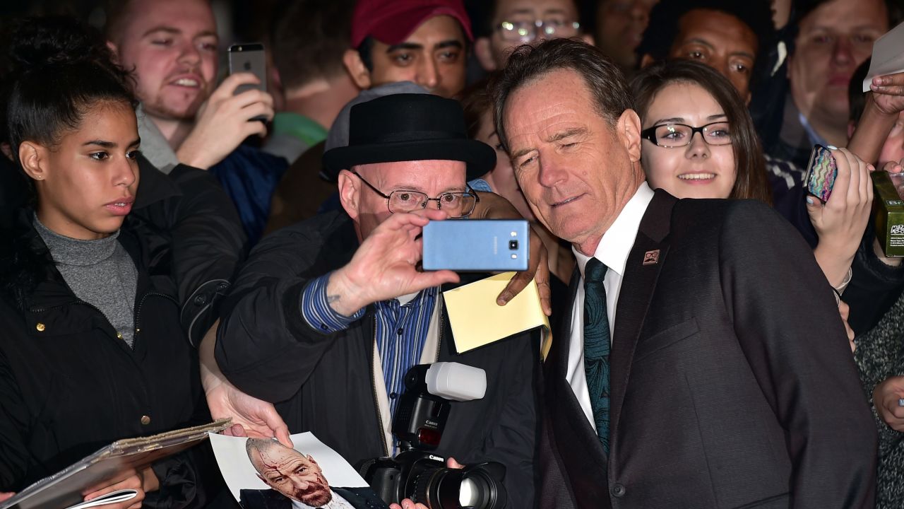 Actor Bryan Cranston stops for a selfie with a man dressed as Walter White, Cranston's iconic character from "Breaking Bad," during the London Film Festival on Thursday, October 8.
