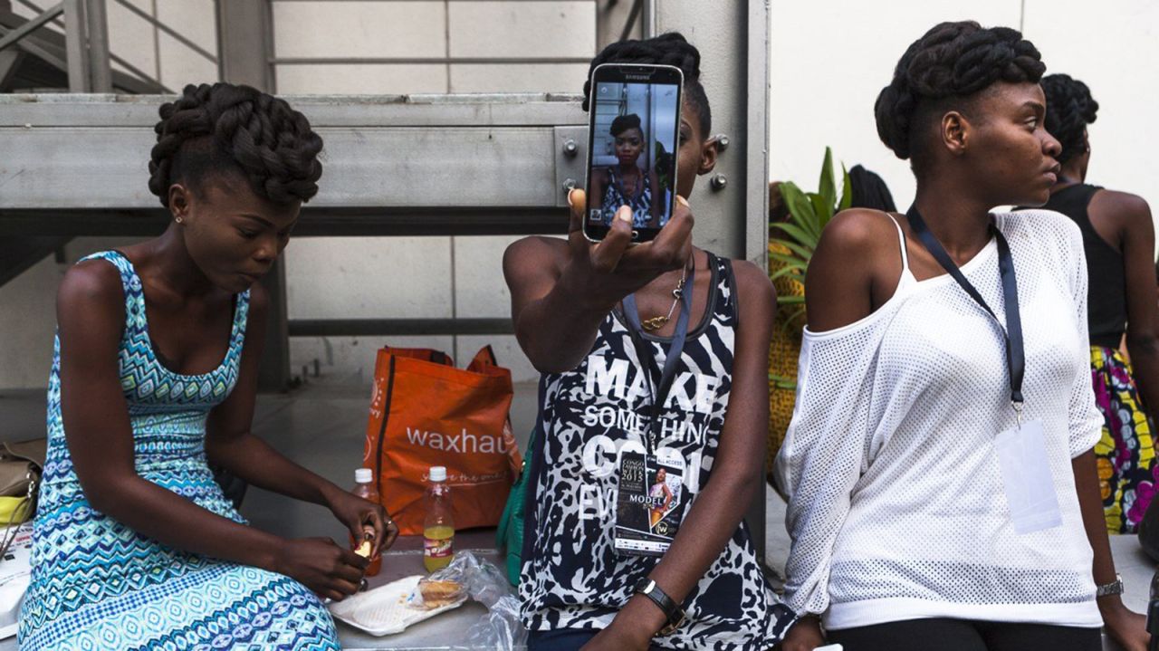 A model takes a selfie before a show at Congo Fashion Week on Thursday, October 8.