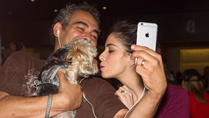 Actress Sarah Silverman smooches a fan's dog Friday, October 9, at the "I Smile Back" premiere in Mill Valley, California.