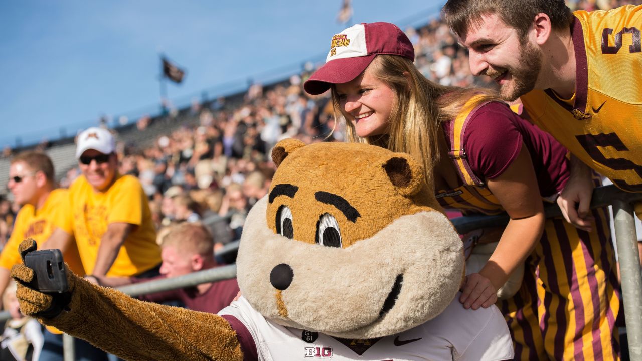 Goldy Gopher, mascot of the University of Minnesota, takes a selfie with fans at a football game in West Lafayette, Indiana, on Saturday, October 10.