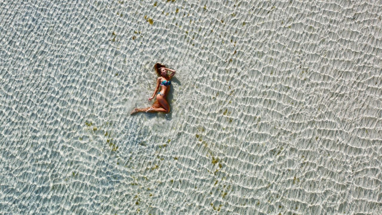 Welcome to Paradise. Here, a drone captures a swimwear shoot in Moreton Island, off the coast of Queensland, Australia. 