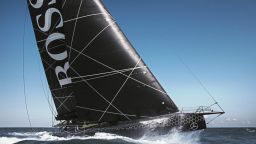 Hugo Boss arcs through the water with Alex Thomson at the helm under blue skies