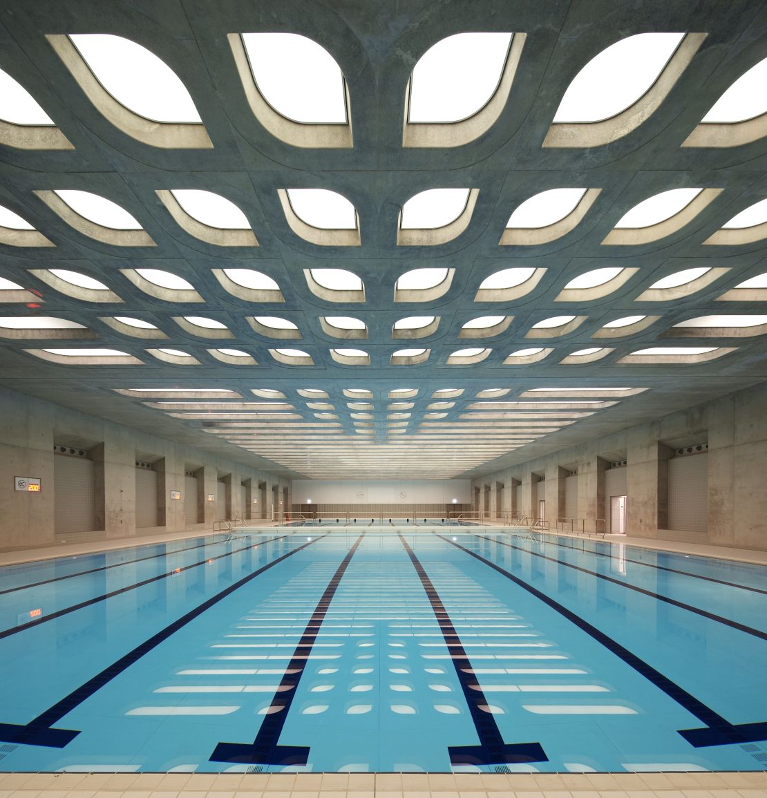 The Aquatics Centre, designed by Zaha Hadid Architects, is inspired by the fluid geometry of water in motion.