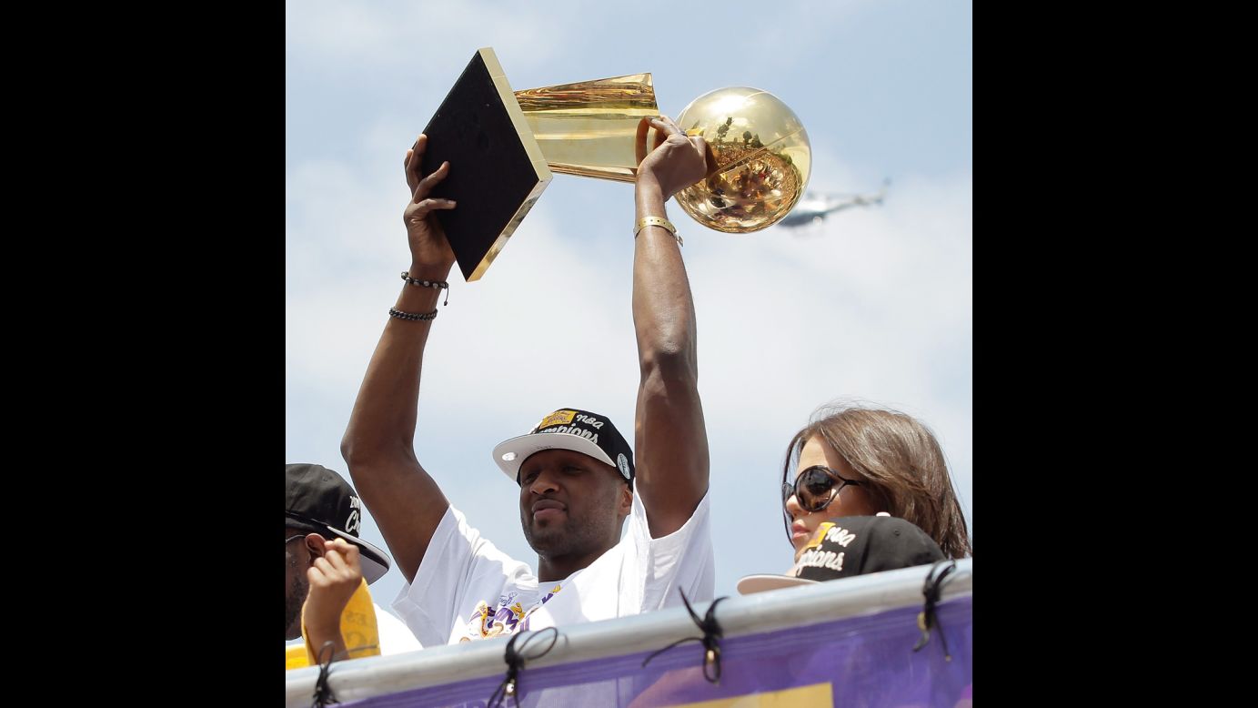 Odom hoists the Larry O'Brien Trophy while riding in the Lakers' victory parade in June 2010. The Lakers defeated the Boston Celtics for a second straight championship.
