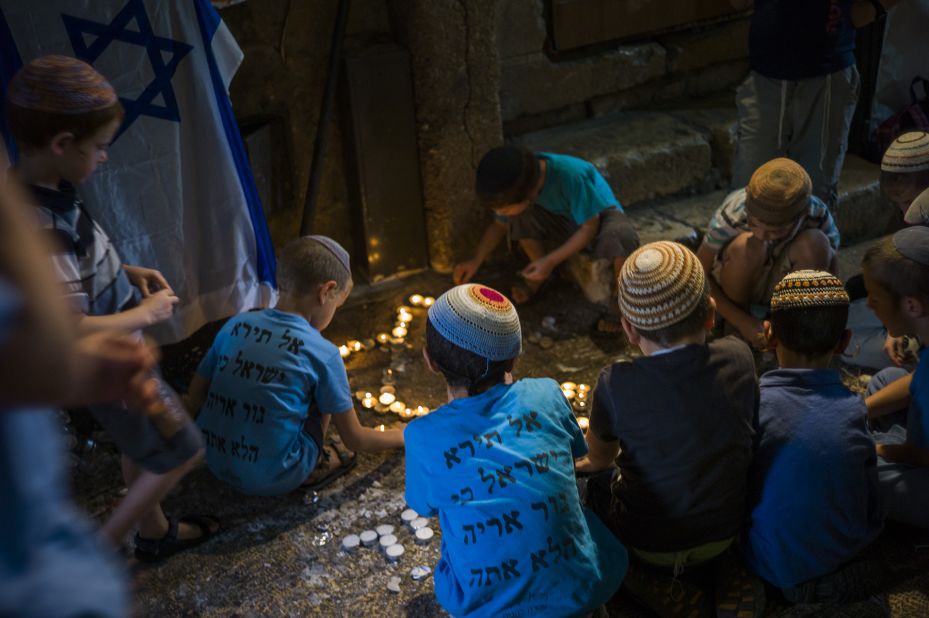 Jewish children pray at the site of a stabbing attack in the Muslim Quarter of Jerusalem's Old City on Monday, October 12.