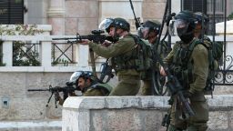 Israeli soldiers aim their weapons towards Palestinian protesters during clashes at the main entrance of the West Bank city of Bethlehem, on October 12, 2015. Frustrated Palestinian youths have defied president Mahmud Abbas as well as an Israeli security crackdown by taking part in violent protests in annexed east Jerusalem and the occupied West Bank, while 18 stabbings have targeted Jews since October 3. AFP PHOTO / MUSA AL-SHAER        (Photo credit should read MUSA AL-SHAER/AFP/Getty Images)