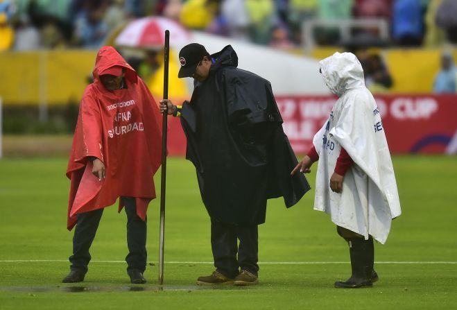 Groundsmen did their best to try to drain the pitch at halftime.