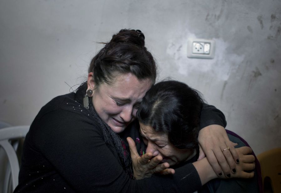 Two Palestinian women cry Wednesday, October 14, during the funeral of Muataz Ibrahim Zawahra, who was killed in clashes with Israeli troops near Bethlehem.