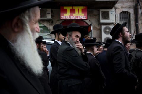 Ultra-Orthodox Jewish men gather around the body of Yeshayahu Kirshavski during his funeral in Jerusalem on Tuesday, October 13. According to the Times of Israel, Kirshavski was killed by a Palestinian <a href="http://www.timesofisrael.com/barkat-joins-thousands-at-funeral-of-jerusalem-attack-victim/" target="_blank" target="_blank">in a car-ramming attack.</a>