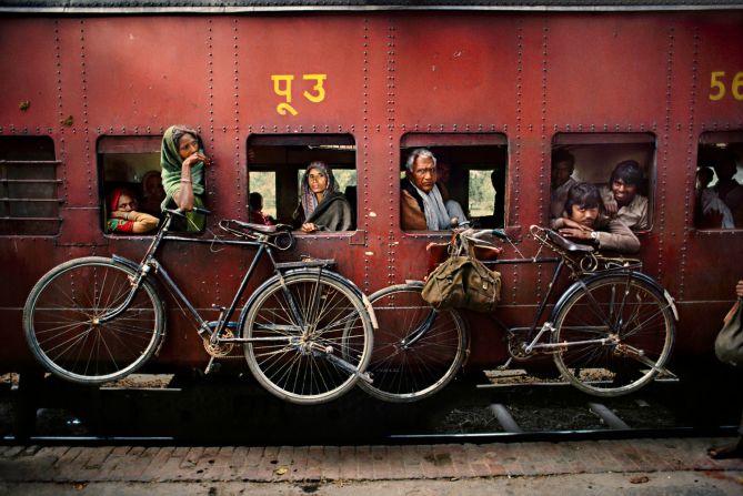 McCurry's remarkable photojournalism career began more than three decades ago, when he crossed the Pakistan border into Afghanistan disguised in native clothes.<br /><br />He returned with rolls of film sewn onto the inside of his garb, and later won the prestigious Robert Capa Gold Medal for his work. <br /><br />This image shows bicylcles hanging from the side of a passing train in West Bengal, 1983.<br />