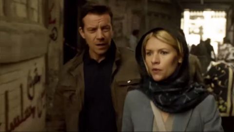 Claire Danes star of hit U.S. TV series "Homeland" walks past graffiti on a wall that says in Arabic: "Homeland is NOT a series." 