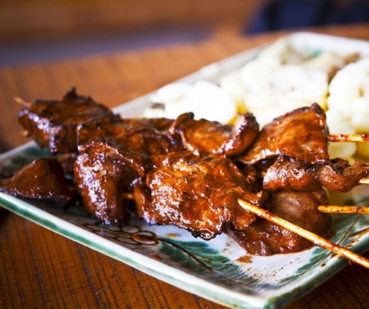 The quintessential Peruvian street food, anticuchos -- beef hearts -- are seasoned with a garlic, cumin, panca chili and vinegar mixture, then slapped on a brazier like a shish kabob.