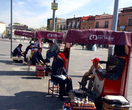 "Rows of shoe shiners in Mexico City are just one of the familiar sights in the Mexican capital," says Davies.