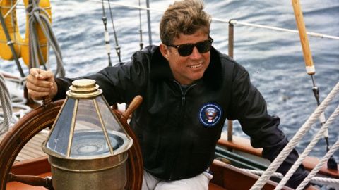 Kennedy at the helm of the U.S. Coast Guard boat Manitou off the coast of Johns Island, Maine.