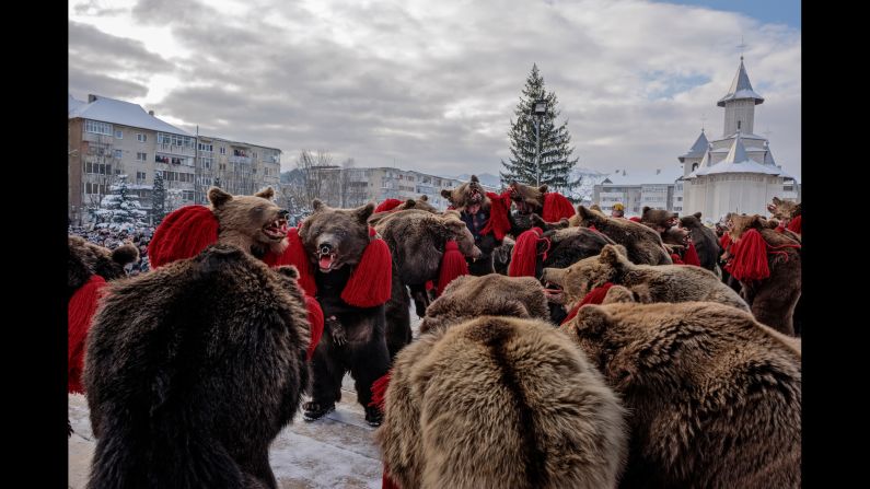 Each winter in the rural Moldova region of Romania, locals dressed in bearskins gather in troupes to perform dances to drive away evil spirits. In 2014, New York-based photographer <a href="http://www.dianazeynebalhindawi.com/" target="_blank" target="_blank">Diana Zeyneb Alhindawi</a> captured the annual festivities.
