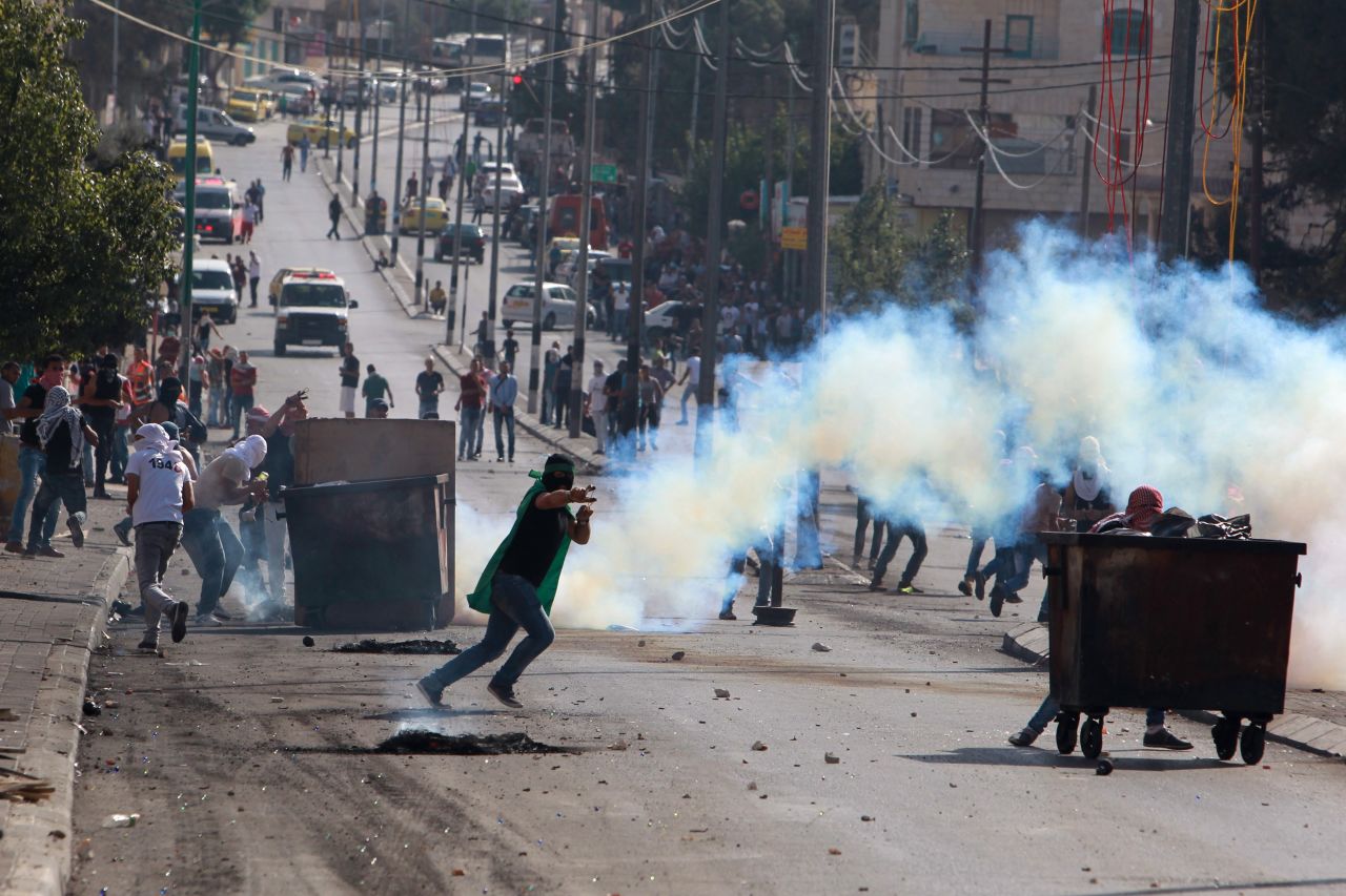 A Palestinian protester uses a slingshot to throw stones toward Israeli security forces during clashes in the West Bank city of Bethlehem on October 16.