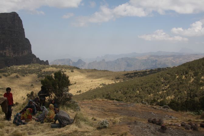 A local family take a rest on the rock-strewn plateaus of Simien Mountain National Park. This breathtaking expanse of green mountains extends across 256 square miles.  