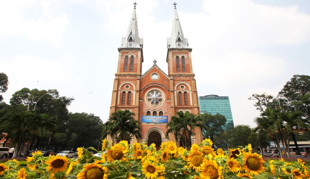 <strong>Saigon Notre-Dame Cathedral Basilica:</strong> At the heart of Ho Chi Minh City's historic District 1, the 200-foot-tall (60-meter) Notre Dame Cathedral towers above a field of sunflowers. Constructed from 1863-1880 by French colonists, the neo-Romanesque architecture style and dramatic spires recall the namesake cathedral in Paris. The landmark is currently undergoing renovations, and is expected to re-open to travelers in 2019.