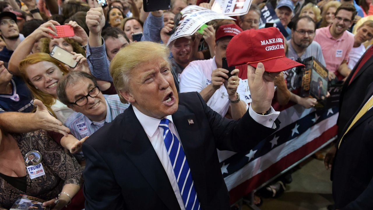 Republican presidential candidate Donald Trump holds up a cap that he signed for a supporter during a rally at the Expo Hall of the Richmond International Raceway on October 14, 2015 in Richmond, Virginia.