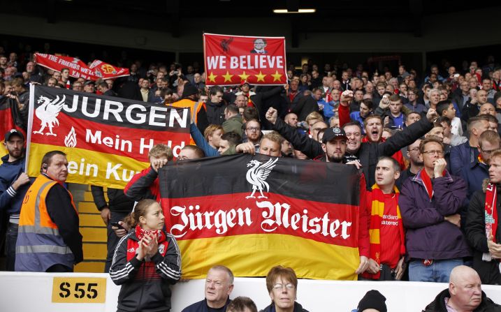 Traveling Liverpool supporters hold up banners in support of their new manager at White Hart Lane.