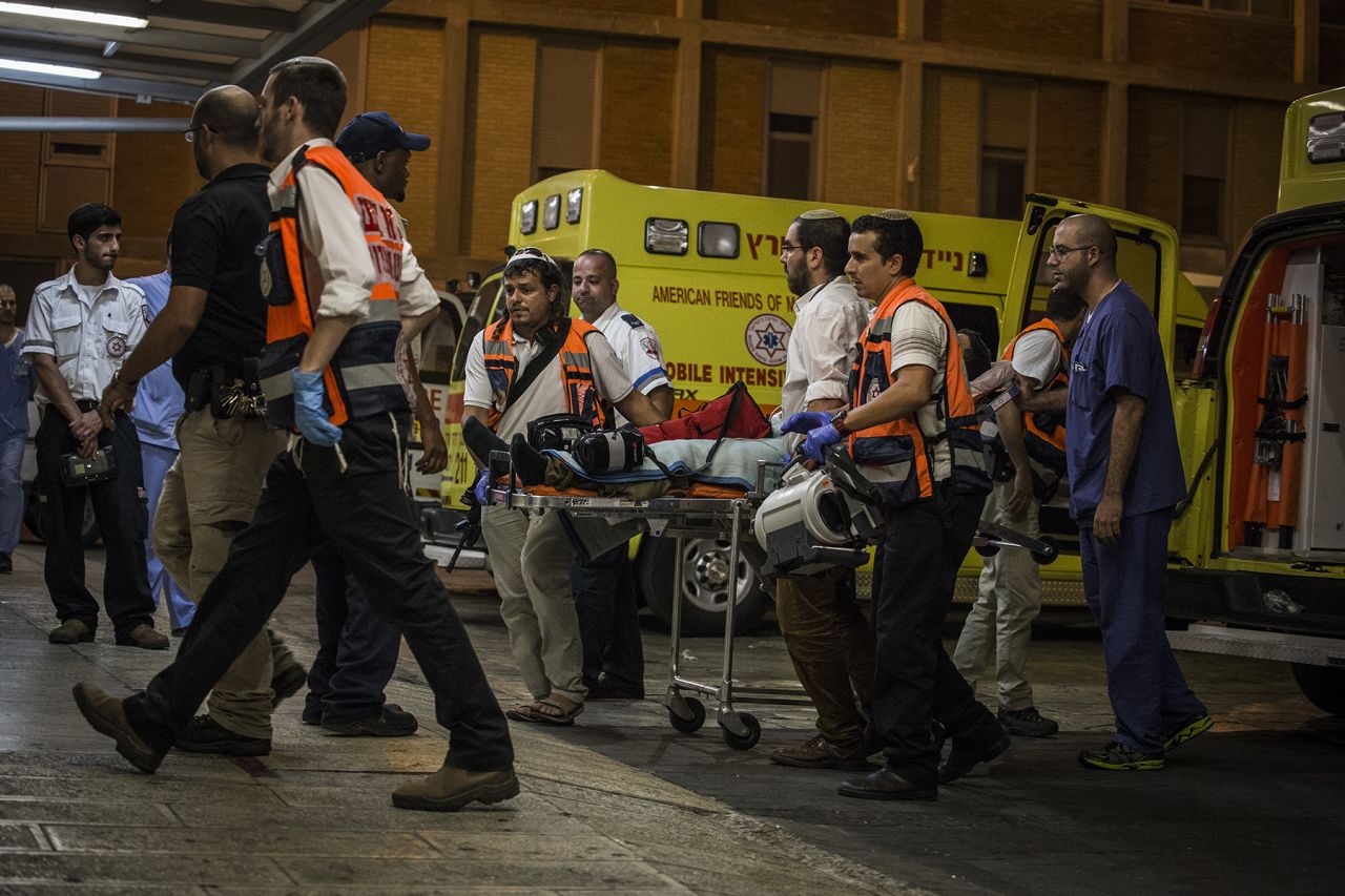 An injured Israeli soldier is taken into Hadas hospital on October 17 in Jerusalem after being stabbed in the West Bank city of Hebron.