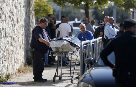 Israeli medics carry away the body of a Palestinian man who attempted to stab an Israeli soldier in the east Jerusalem Jewish settlement of Armon Hanatsiv, adjacent to the Palestinian neighborhood of Jabal Mukaber, on October 17.
