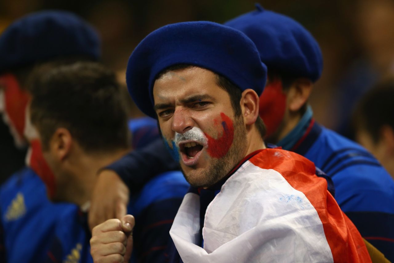  A France fan cheers his country on from the stands but ultimately to little avail.