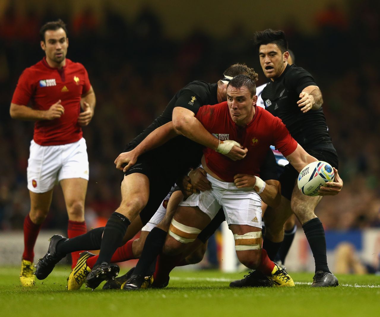 Louis Picamoles of France is tackled by Wyatt Crockett of the New Zealand All Blacks (L) and Nehe Milner-Skudder of New Zealand.
