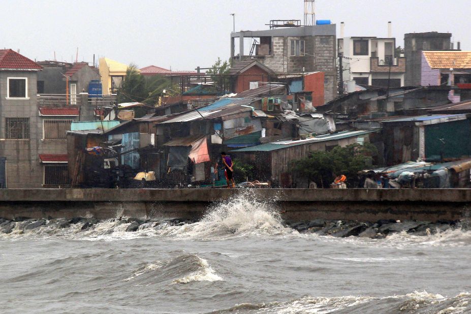 A man walks on a breakwater of Manila Bay in strong wind from Typhoon Koppu in Navotas,  Philippines, on Sunday October 18. Koppu is forecast to lumber over the country's main island of Luzon at an excruciatingly slow pace and dump huge amounts of rain on the rugged terrain, setting off floods and landslides.