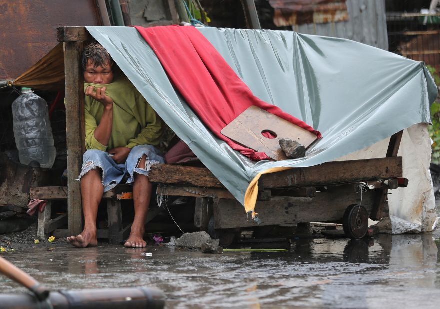 A man sits inside his makeshift home in Navotas on October 18. 
