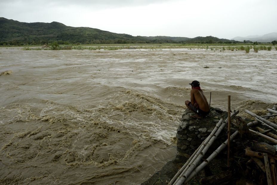 A man looks at the rising water of the Magat River in Bayombong on October 18.