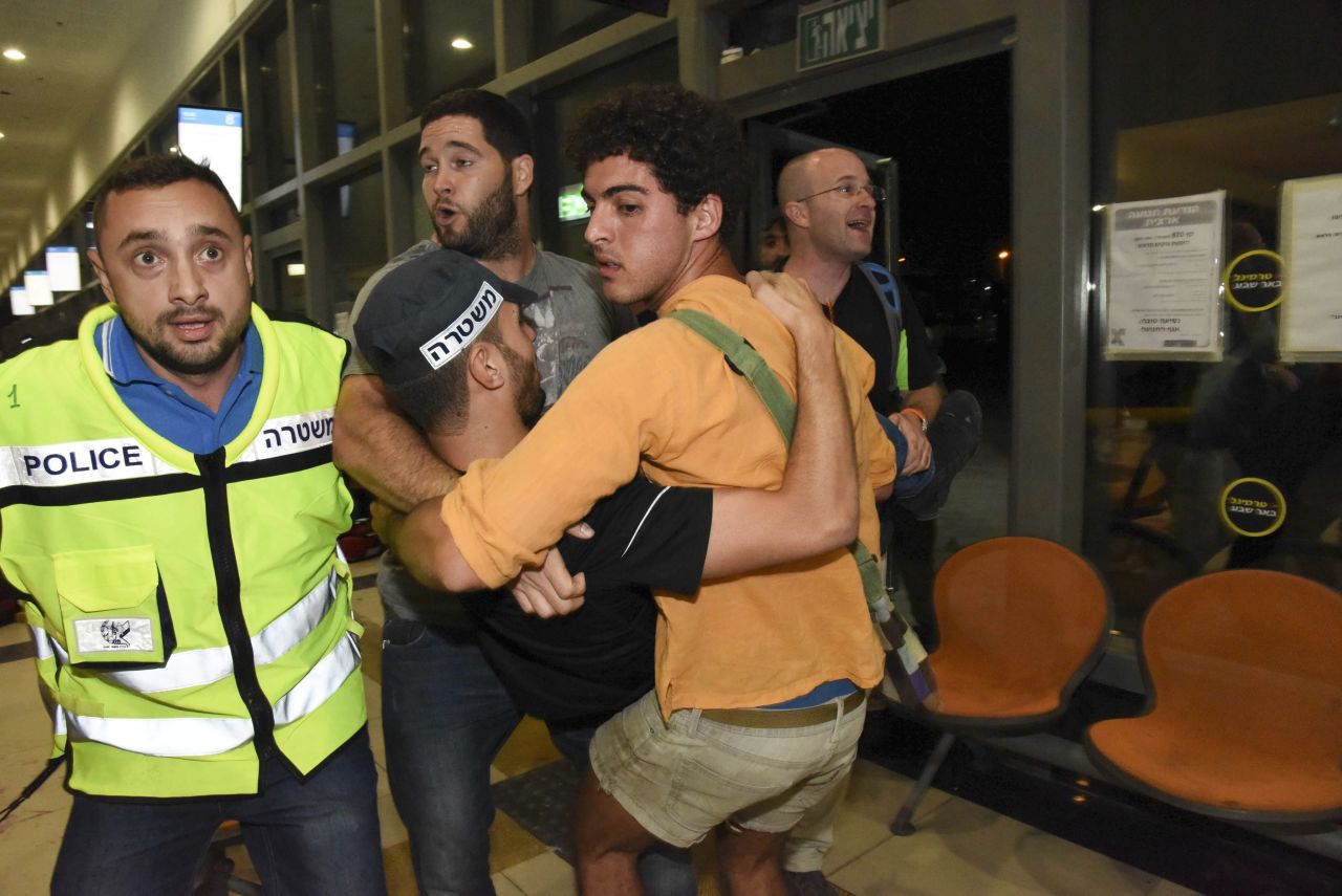 A police officer injured during an attack at a bus station in Beer Sheva, Israel, is carried from the scene on Sunday, October 18. Ten people were injured and one person, a soldier, was killed, according to police spokesman Micky Rosenfeld. The attacker -- identified by police as a Bedouin man -- was killed in the shootout on Sunday, but so was an Eritrean migrant who was apparently misidentified by a security guard as a second attacker, police said.