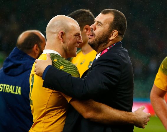 Stephen Moore of Australia celebrates with head coach Michael Cheika after their team's last-gasp victory over Scotland.