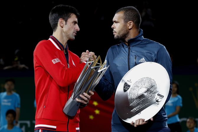 Djokovic and Tsonga of France pose with their trophies after their men's singles final match of the Shanghai Masters.  