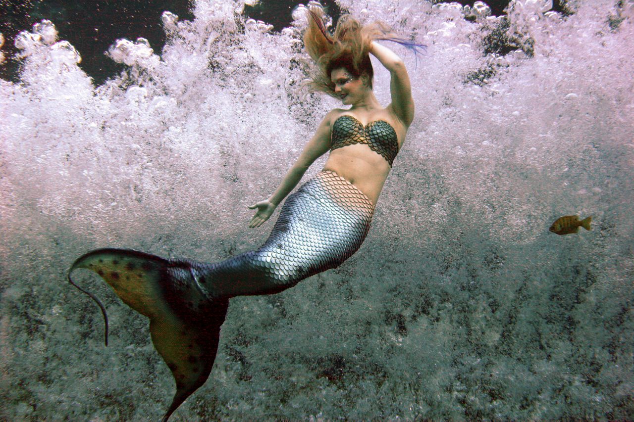 A mermaid grins and bears it while performing in chilly water at Weeki Wachee Springs.