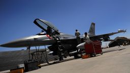 Two US Airforce grounstaff inspect a F-16 fighter jet at the Bagram Airbase in the Parwan province, some 50 kms north of Kabul on August 10, 2009.