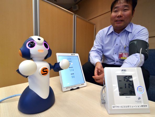 This is "Sota," a humanoid robot produced by Japanese robotics company Vstone, which uses NTT technology to control multiple electronic devices. NTT is testing its use to monitor elderly people at a retirement home, and is developing other services for elderly people and children.