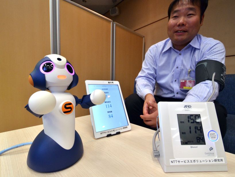 This is "Sota," a humanoid robot produced by Japanese robotics company Vstone, which uses NTT technology to control multiple electronic devices. NTT is testing its use to monitor elderly people at a retirement home, and is developing other services for elderly people and children.