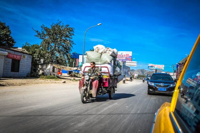 As time went by, we left the gorgeous landscape to discover a different side of mainland China. There were flat, endless villages, and a lot of electric motorcycles. 