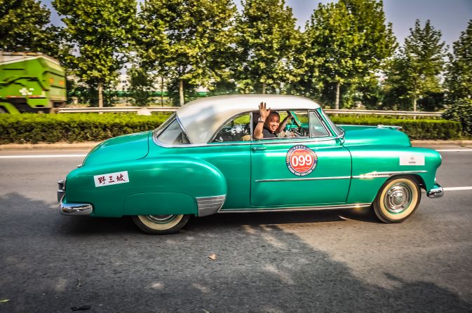 This morning the chief of police congratulated all the teams from all over the world and their beautiful cars. Then he asked, "Do you know the average driving experience in China? 3 years. I trust you all with your great experience to show the way and be respectful." This team is driving a 1951 Chervolet Bel Air. <br />