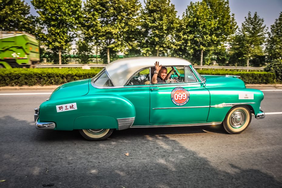 This morning the chief of police congratulated all the teams from all over the world and their beautiful cars. Then he asked, "Do you know the average driving experience in China? 3 years. I trust you all with your great experience to show the way and be respectful." This team is driving a 1951 Chervolet Bel Air. <br />