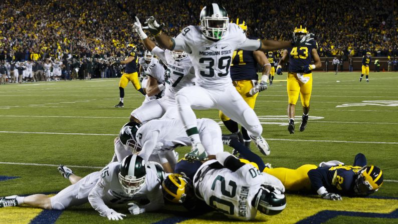 Michigan State players crash into the end zone after Jalen Watts-Jackson <a href="index.php?page=&url=http%3A%2F%2Fbleacherreport.com%2Farticles%2F2580146-michigan-state-wins-on-walk-off-td-after-michigan-punter-fumbles-on-final-play" target="_blank" target="_blank">scored an improbable touchdown</a> to defeat Michigan on Saturday, October 17. Michigan looked to have the game in hand until fumbling on a punt play with 10 seconds left. Watts-Jackson returned the ball for a 27-23 victory.