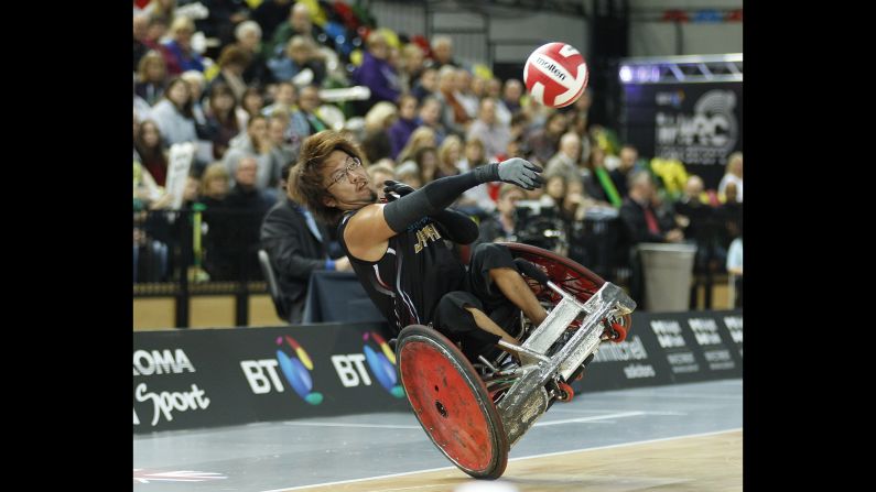 Japan's Daisuke Ikezaki throws a pass before crashing during a wheelchair rugby match in London on Friday, October 16. Japan was playing Australia for the bronze medal in the World Wheelchair Rugby Challenge.