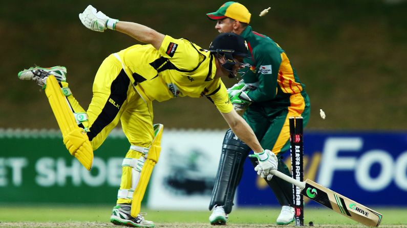 Western Australia's Adam Voges, left, is run out by Tasmania during a cricket match in Sydney on Saturday, October 17.