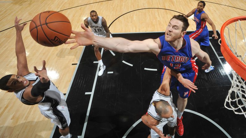 San Antonio's Ray McCallum, left, and Detroit's Aron Baynes reach for a rebound during an NBA preseason game in San Antonio on Sunday, October 18.